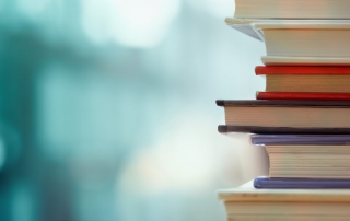 Book stack in the library room and blurred bookshelf, business and education background