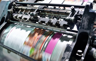 Detail shot of the workings of a printing factory. The commercial designs displayed in this image represent a simulation of a real product and have been changed or altered enough by our team of retouching and design specialists so that they are free of any copyright infringements